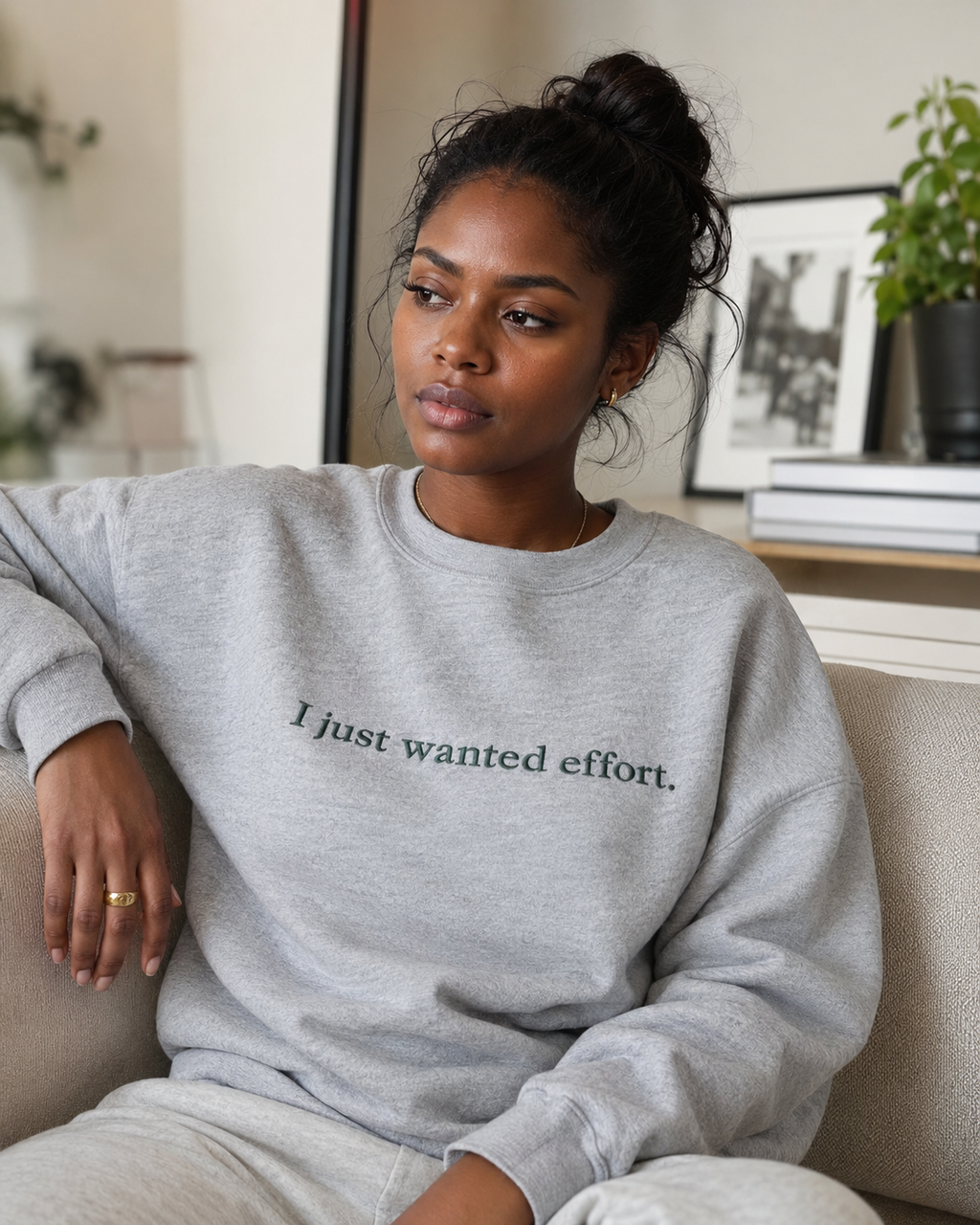 Folded Heather Gray crewneck sweatshirt with dark embroidery reading “I just wanted effort.” on a light background.