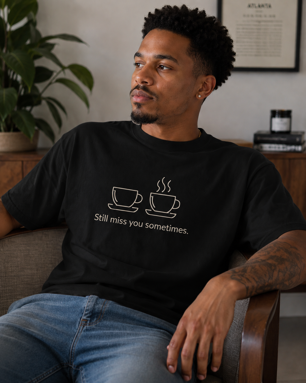 Black T-shirt with two bone-coloured coffee cups above the phrase “Still miss you sometimes.”